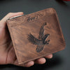 A brown embossed PU leather slim wallet with a black eagle design is held in a hand.