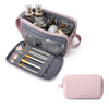 A pink cosmetic toiletry bag open, showing brushes and various small beauty tools inside.