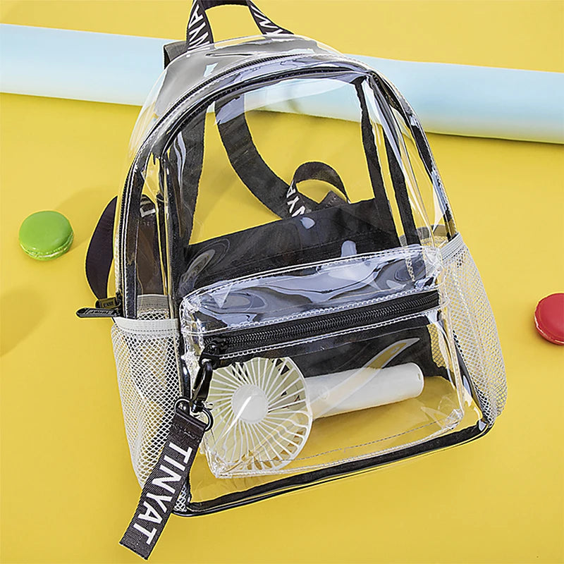 A clear plastic backpack with black straps and mesh pockets is shown on a yellow surface.