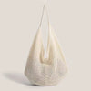 A cream-colored crochet shoulder bag with a mesh detailing, shown against a light background.