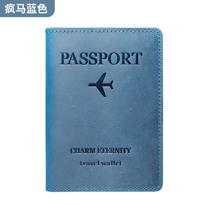 A blue leather passport holder with silver lettering and a black airplane emblem.