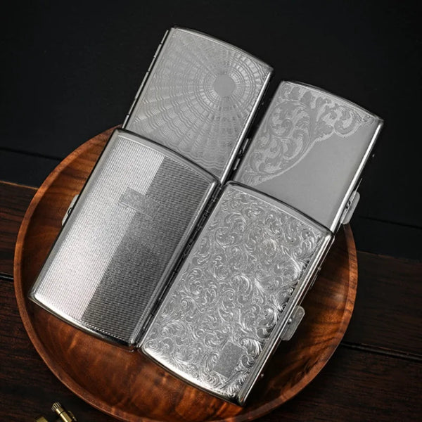 A silver compact metal cigarette case with an ornate design is displayed on a wooden surface.