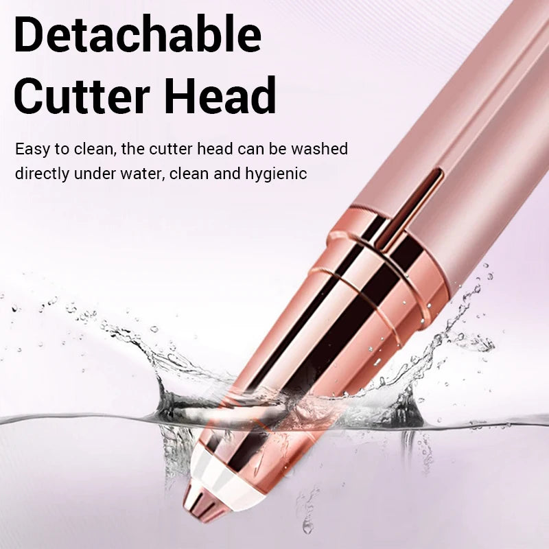 A close-up of a pink detachable cutter head being washed under running water.