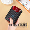 A hand holds a black leather wallet with a thumb hole, displaying a red credit card.