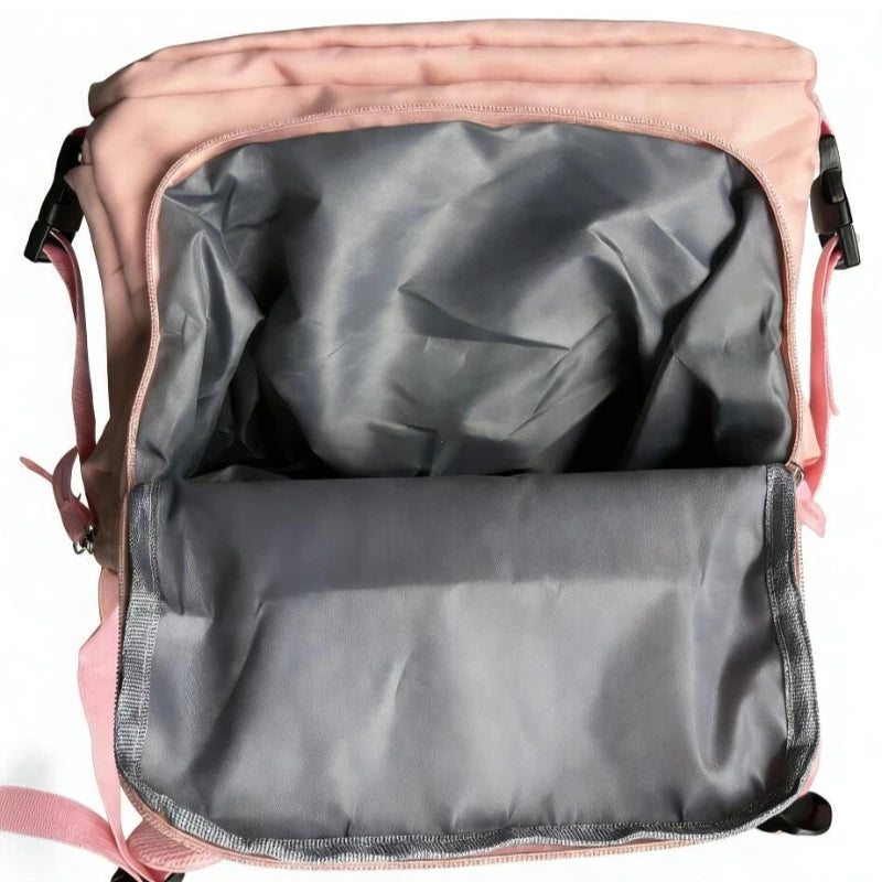 A pink compact travel backpack with a gray interior lining is shown open.