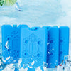 Blue reusable ice packs with snowflake designs surrounded by ice and water.