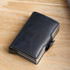 A black premium double layer ID card holder wallet resting on a light wooden surface.