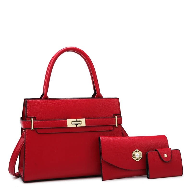A red leather handbag with gold hardware shown in a studio setting.