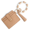 A beige silicone bead and leather card wallet with a white and nude beaded bracelet.