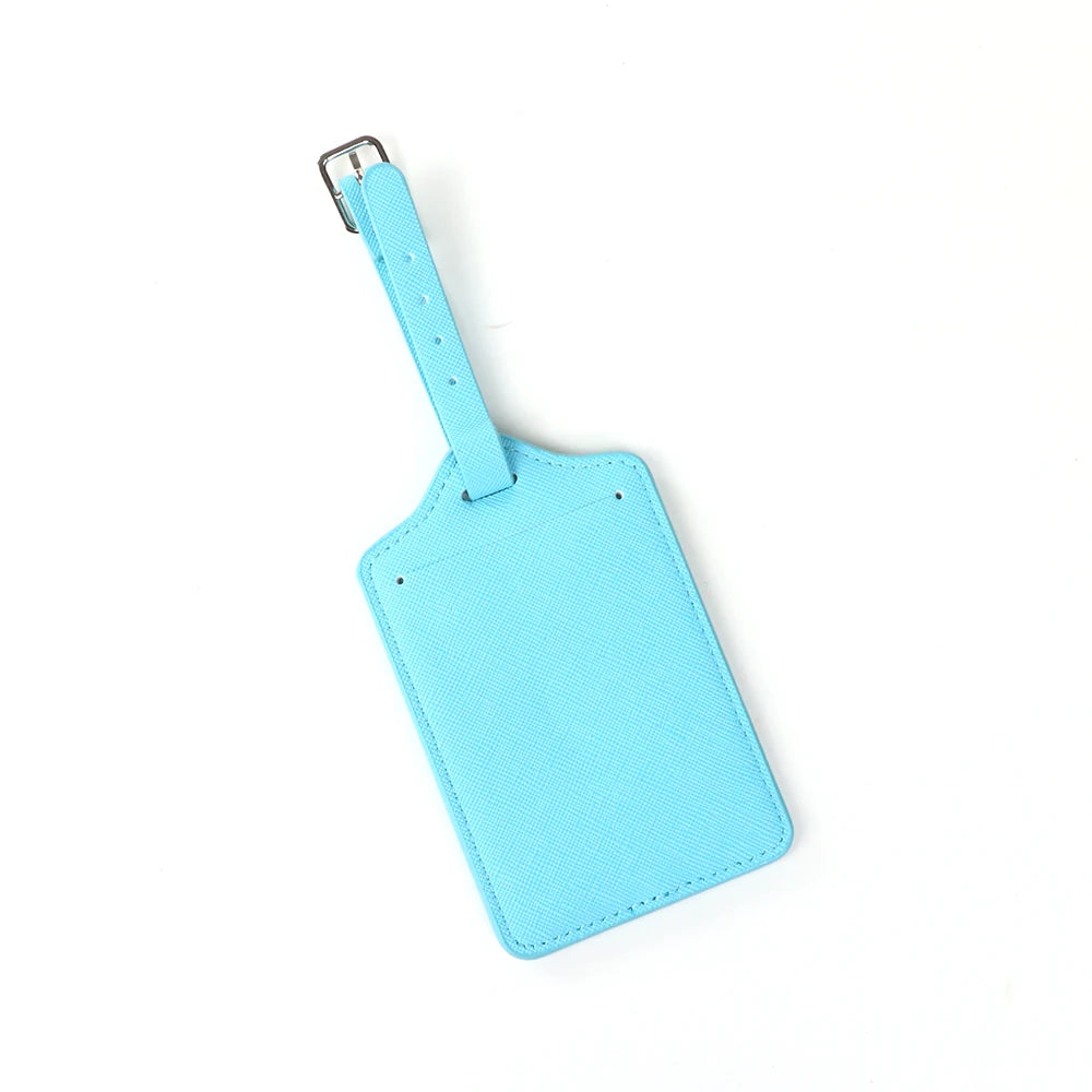 A light blue custom PU leather luggage tag with a silver clip attached.