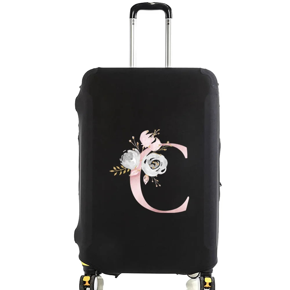 Black luggage with a pink floral monogram design on the side.