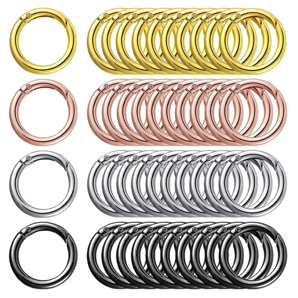 A collection of stainless steel spring clasp keychain rings and carabiner clips in various finishes.