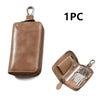 A brown compact PU leather key organizer wallet with a flap and multiple key slots.