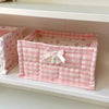 Pink quilted cotton storage basket with a checkered pattern and lace flower design