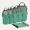 A set of six teal packing cubes with black handles and gray compression fabric are displayed on a white background.