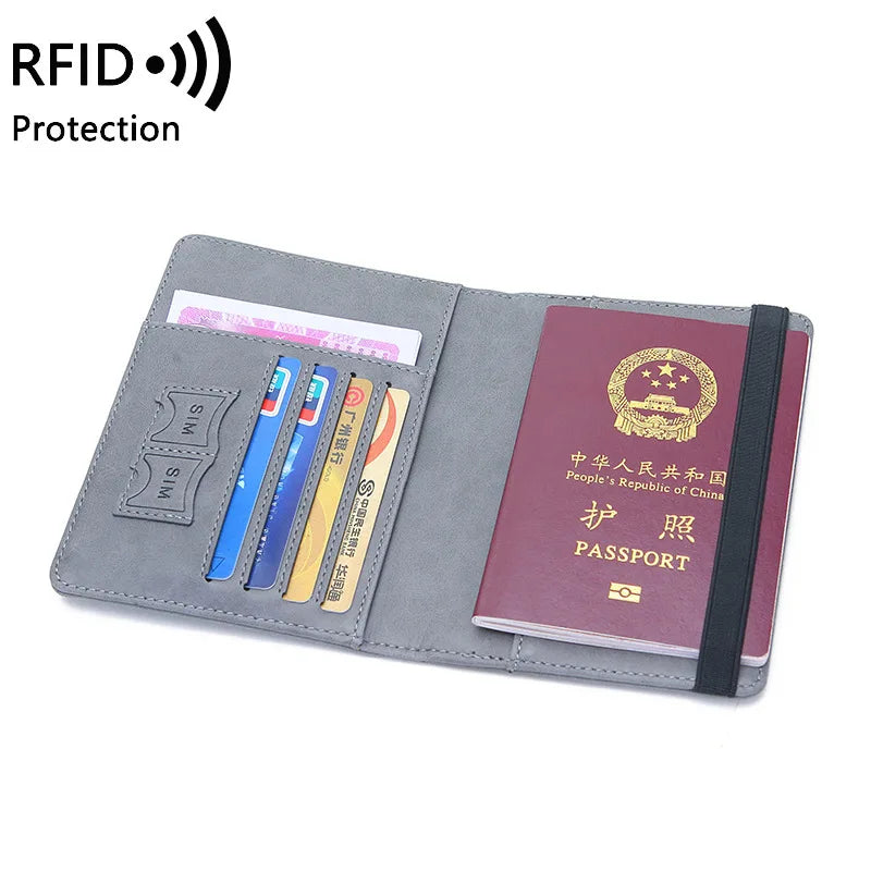 Gray PU leather passport holder with RFID blocking features and slots for passports and cards.