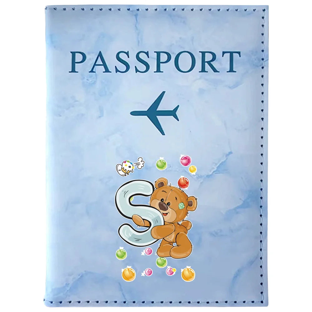 Light blue passport card holder featuring a vintage letter print design with a blue airplane and a teddy bear.