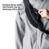 A hand is shown placing a black padded strap with a zip pocket into a gray jacket pocket.