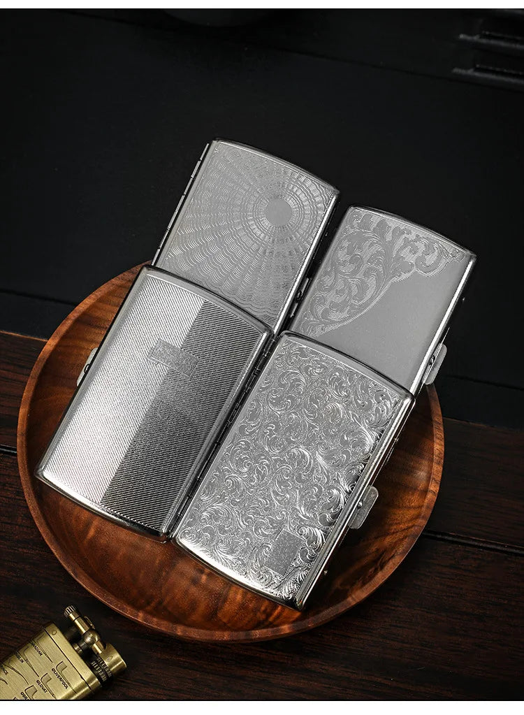 A silver metal cigarette case is shown open, resting on a wooden surface.