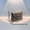 A sparkling rhinestone leather evening clutch bag is displayed under a spotlight.