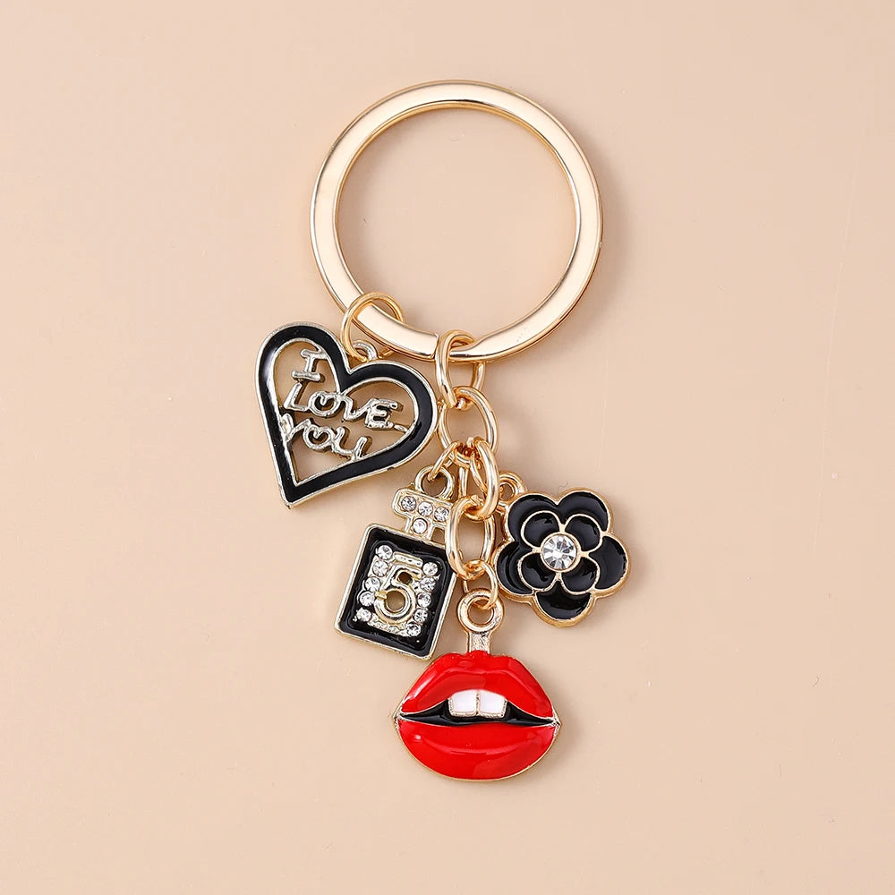 Gold-toned enamel keychain featuring a heart, a number 5, and a red lip design.