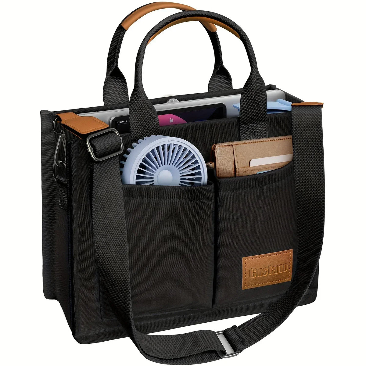 Black canvas tote handbag with brown leather accents and a fan inside