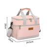 A pink insulated thermal lunch bag with gray straps and a beige accent tag.