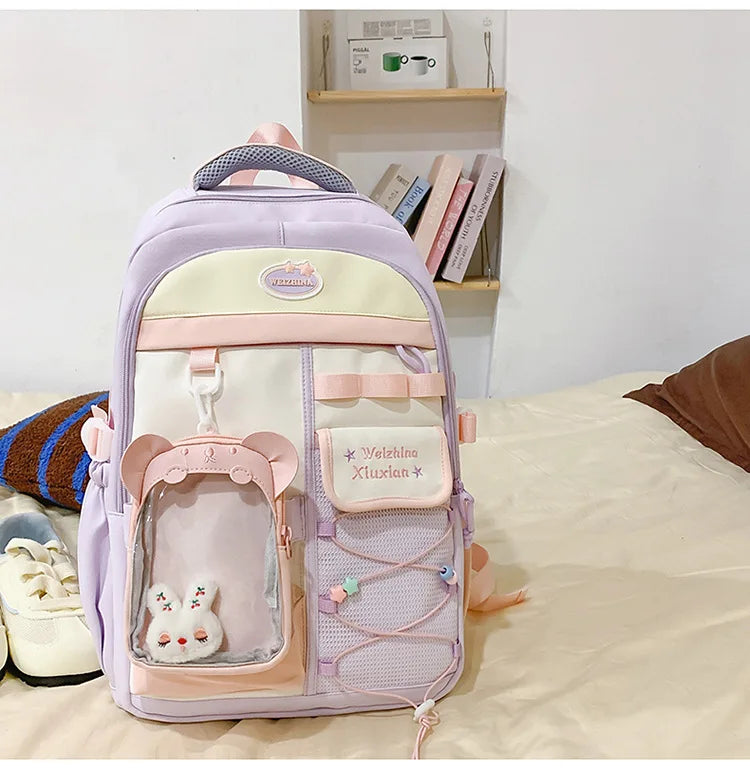 A light purple and pink Candy Color Campus backpack with a padded front pocket and decorative details.
