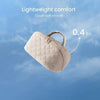 A light beige, quilted makeup organizer bag is shown against a blue sky background.