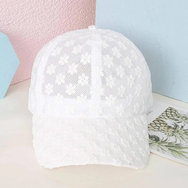 White summer floral mesh snapback baseball cap shown on a light surface.