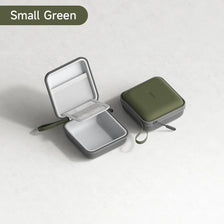 A small green portable cable organizer pouch with an open lid displaying a white mesh insert.