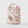 Pink fashion backpack featuring a cow print design and Minnie Mouse embellishments.
