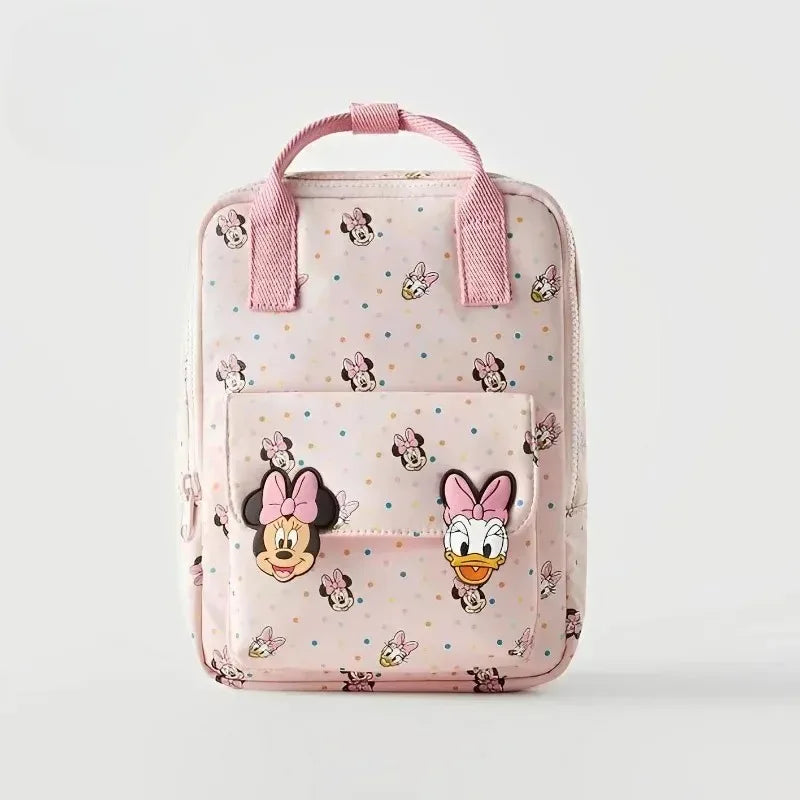 Pink fashion backpack featuring a cow print design and Minnie Mouse embellishments.