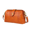 A genuine leather crossbody bag in a warm tan or cognac color with a brown leather strap and buckle closure.