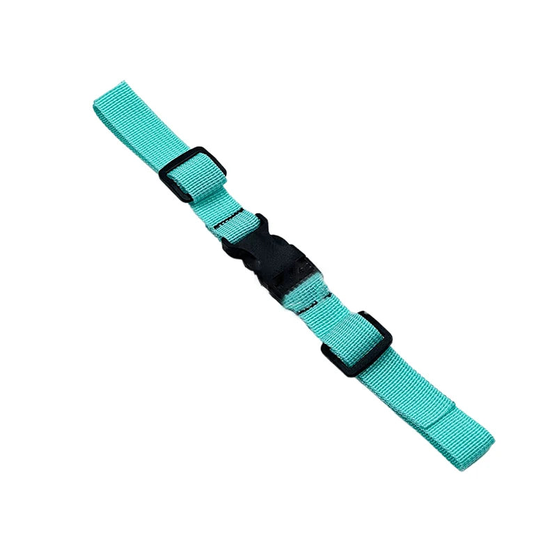 A teal and black adjustable tactical backpack chest strap harness.