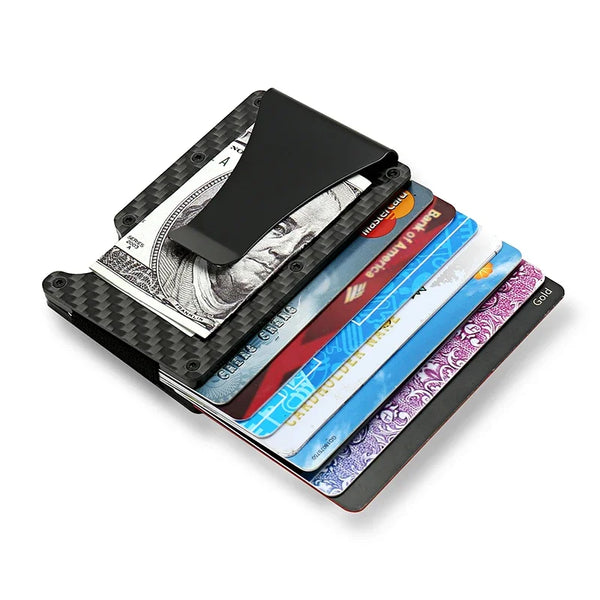 A stack of black metal RFID protection cards and credit cards in various colors resting on a dark surface.