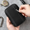 A hand holds a black portable multi-tool organizer pouch, showing the zippered compartment.