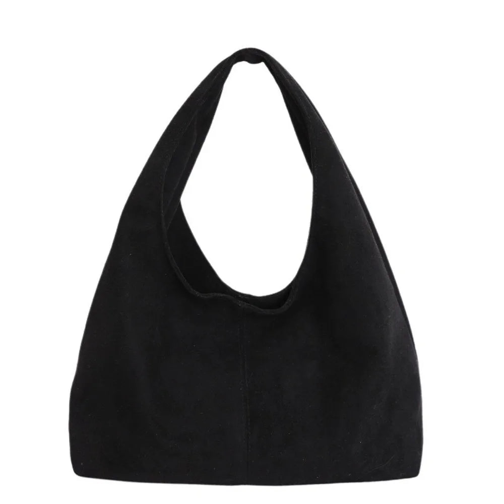 A black retro suede shoulder tote bag shown against a white background.