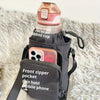 A dark fabric bag is shown carrying a water bottle and featuring a front zipper pocket for a mobile phone.
