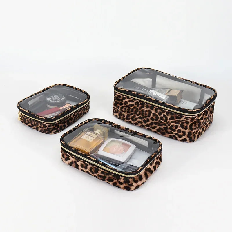 A leopard print waterproof cosmetic organizer bag with a clear lid and brown lining is shown on a white background.