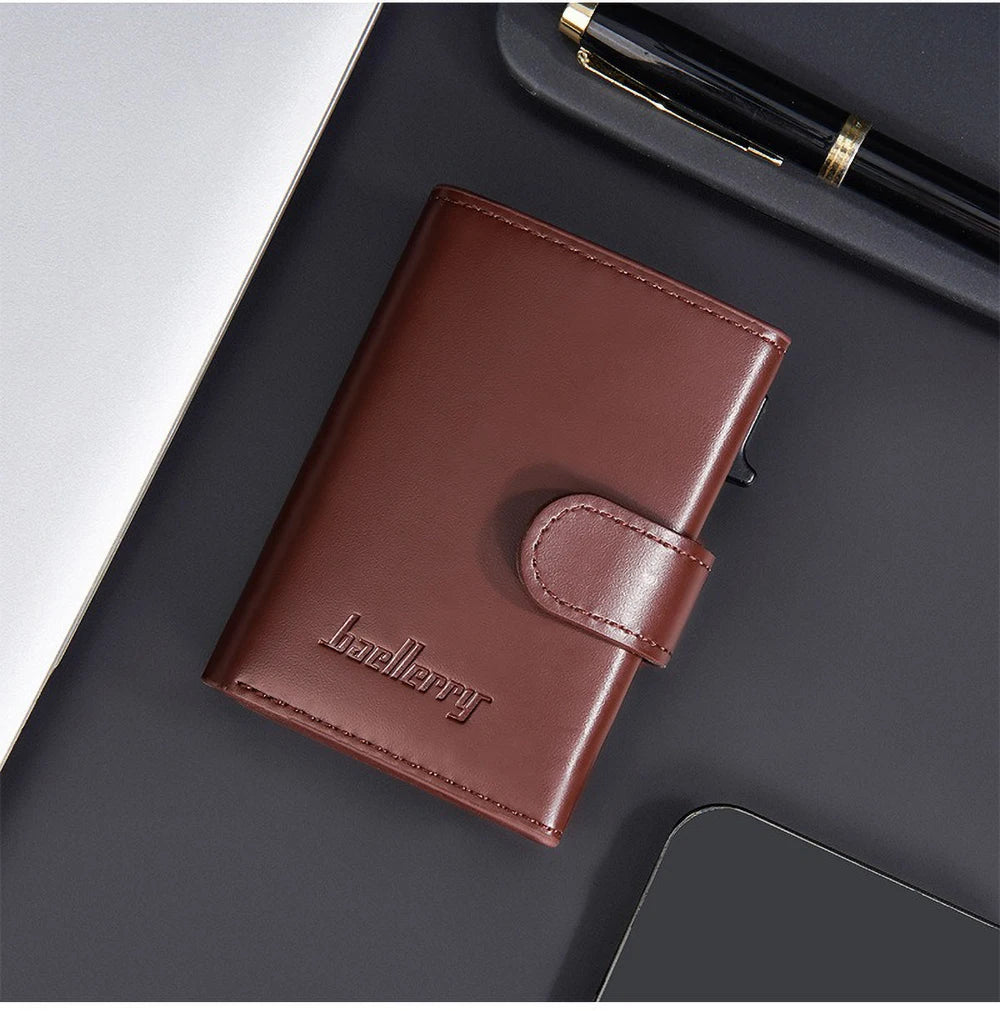 A brown leather card holder with a pop-up slide is shown on a dark surface next to a pen and a smartphone.
