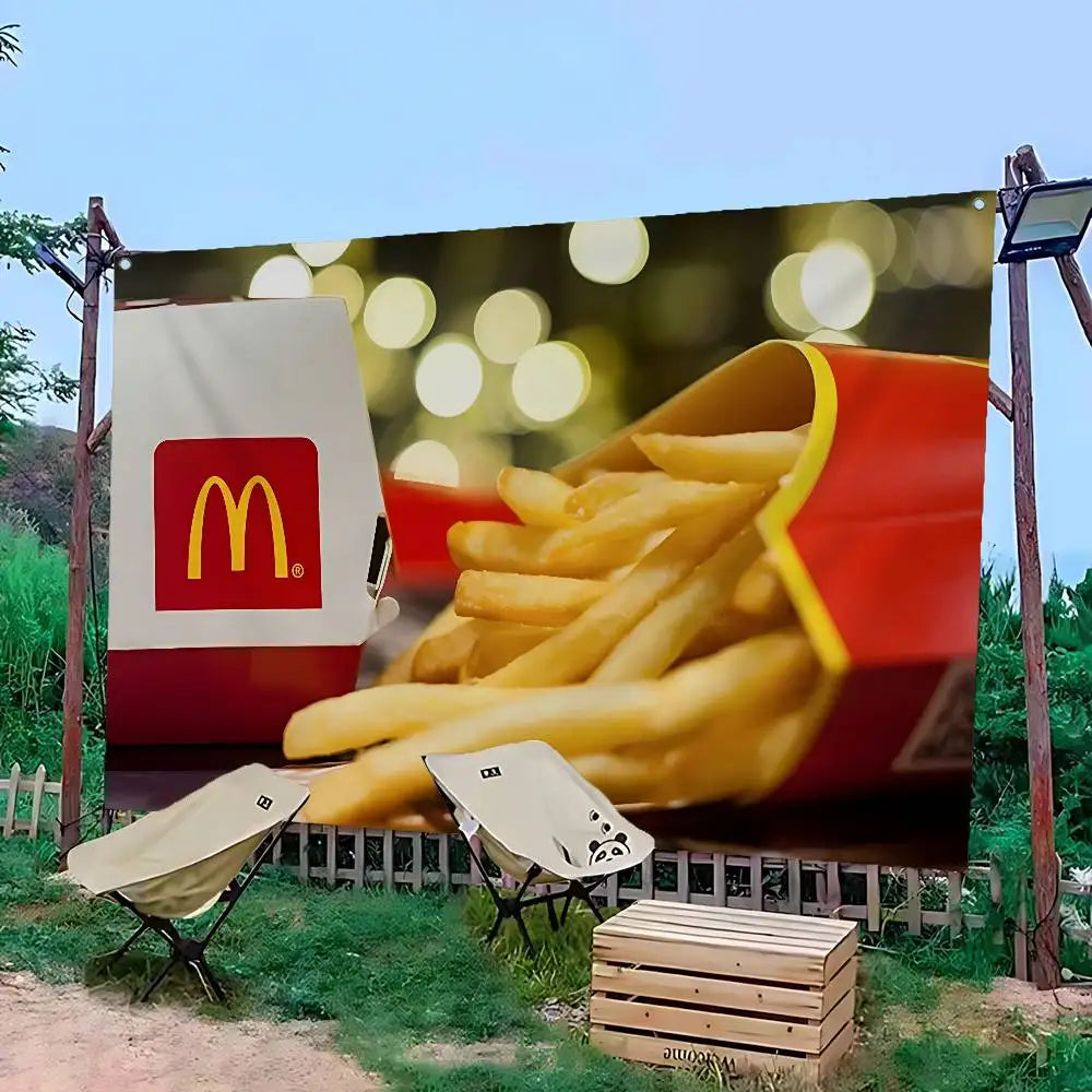 A large banner featuring a pile of french fries and the McDonald's logo against a green outdoor background.