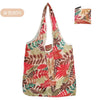 A reusable fashion shopping tote bag featuring a floral pattern with shades of red, green, and beige.