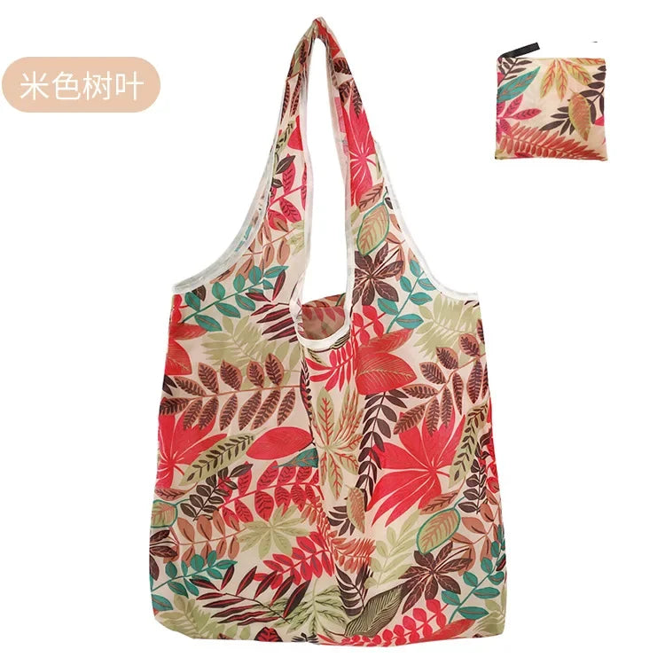 A reusable fashion shopping tote bag featuring a floral pattern with shades of red, green, and beige.