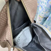 A close-up view of a light beige backpack with white polka dots, showing the interior lining and zipper details.