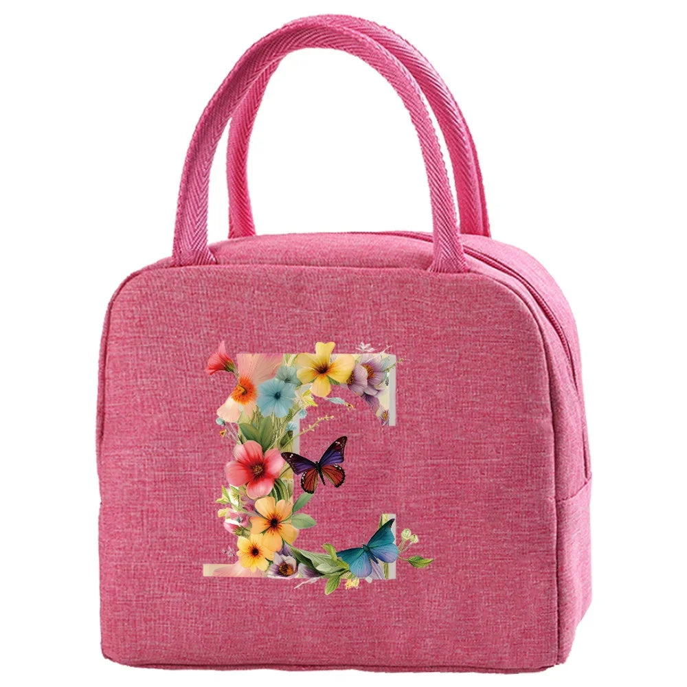 A pink insulated canvas lunch bag decorated with colorful floral and butterfly embroidery.