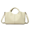 A beige luxury soft leather women's tote bag with a handle and shoulder strap.