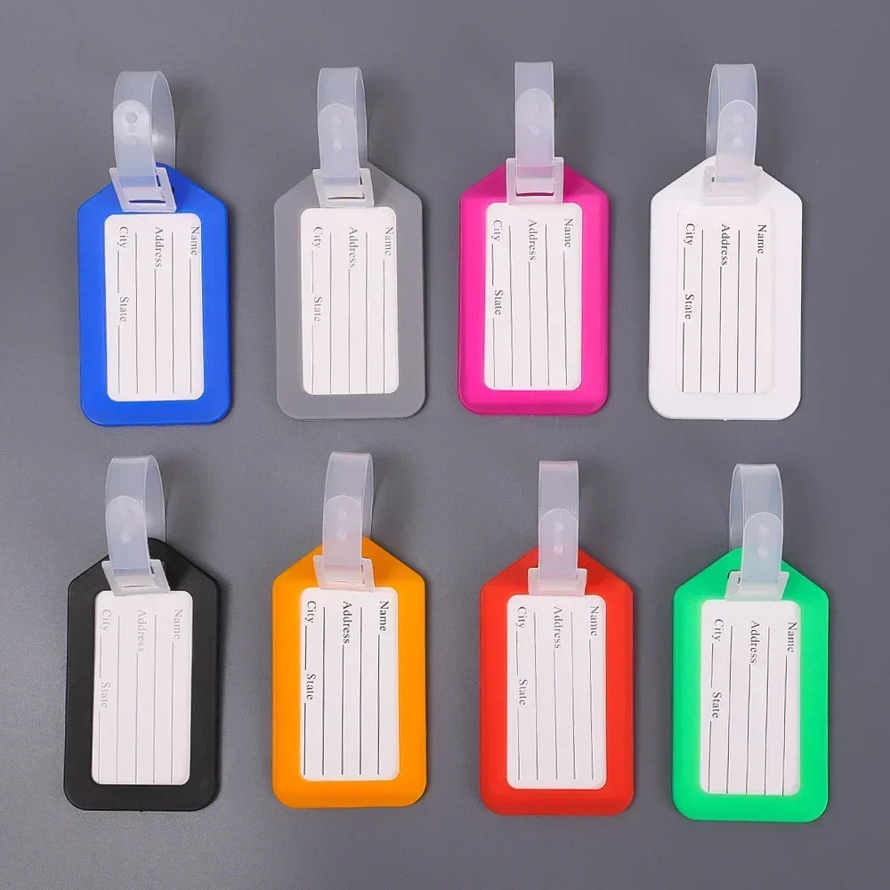A set of six customizable luggage tags in various colors including blue, gray, pink, white, orange, and green.