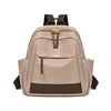 A beige lightweight nylon travel backpack with brown accents and a zippered front pocket.