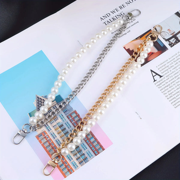 A silver chain necklace with white pearls and a leather strap displayed on a white background.